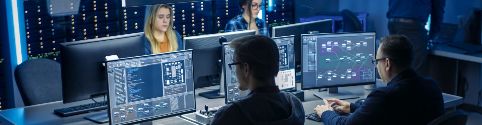 Team of IT Programers Working on Desktop Computers in Data Center System Control Room. Team of Young Professionals Working In Software and Hardware Development, Doing Coding